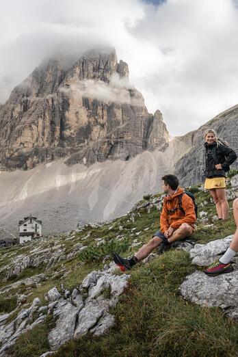 A man and two women are hiking in the Sexten Dolomites