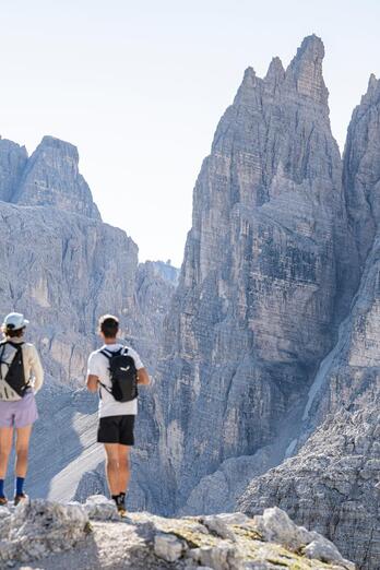 Two women and a man are looking at the Three Peaks