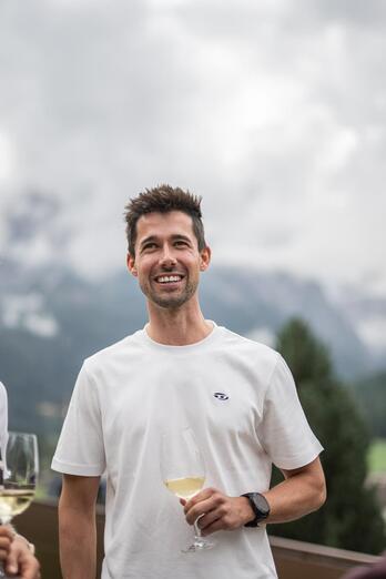 A group of people enjoys a glass of white wine