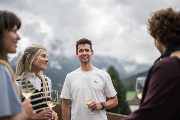A group of people enjoys a glass of white wine