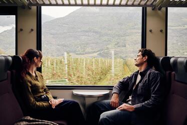 A man and a woman are sitting on the train