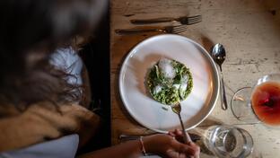 A person enjoys a risotto dish