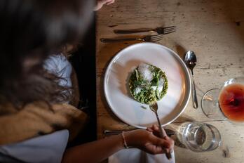 A person enjoys a risotto dish