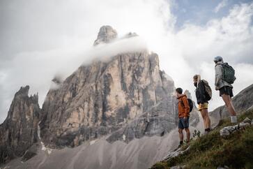 Two women and a man are looking at the Three Peaks