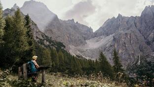A woman looks at the Dolomites