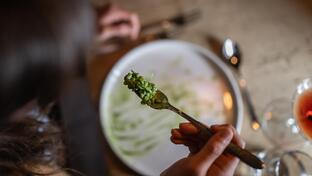 A person enjoys a risotto dish