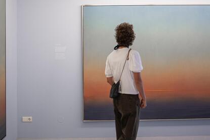 A man looks at a painting